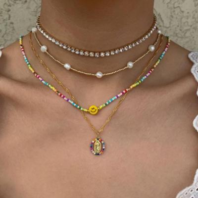 China 4pcs/set TRENDY Boho Colored Rice Bead Smile Face Necklace Rainbow Color Round Buddha Pendant Necklace for sale