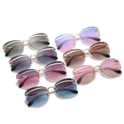 China Fashion Sunglasses Cat Eye Frameless Sunglasses Women Metal Retro Gradient Round Sunglasses for sale