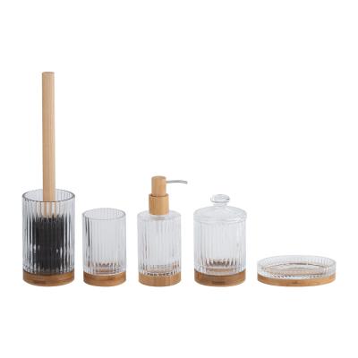 China Glass bathroom countertop accessories clear with round shape and ribbed vertical stripe and wood base toothbrush tumbler soap dish cotton jar Te koop