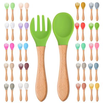 China American Style Baby Feeding Utensils Kid Training Eat Solid Food Dishes Children Spoon Fork Tableware Wooden Handle Silicone Spoon And Fork Set for sale