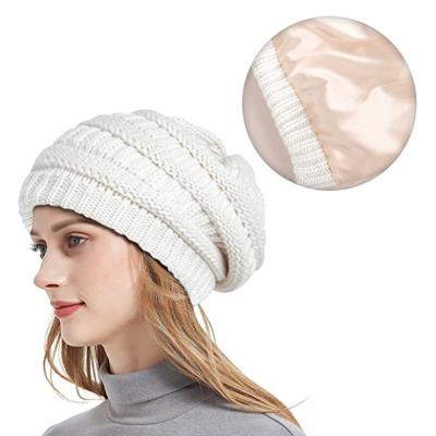 China Fashion JOINT Wholesale Cable Chunky Warm Knit Beanie Hat Fur Pompom Custom Women Solid Warm Satin Silk Striped Winter Hats Beanie for sale