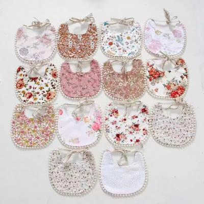 China INS Floral Print Bib Baby Feeding Bib Popular Infant Infant Washable Toddler Boho Reversible Bib With Small Pom Pom for sale