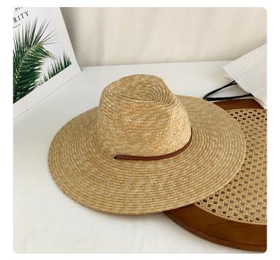 China Big Picture Yolo Panama Jazz Straw Hat Women Summer Sunscreen Strap Windproof Seaside Brim Hat for sale