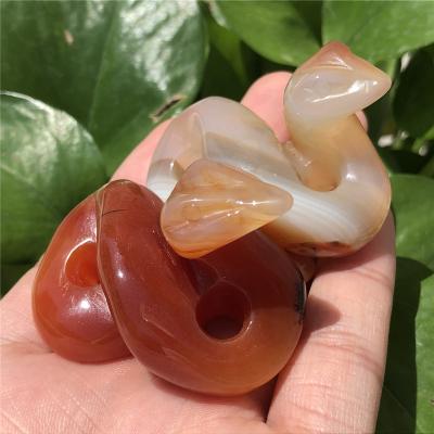 China Wholesale Natural Skulls Figurine Europe Crystal Red Agate Snake Hand Carved Healing Crystal Statue for sale