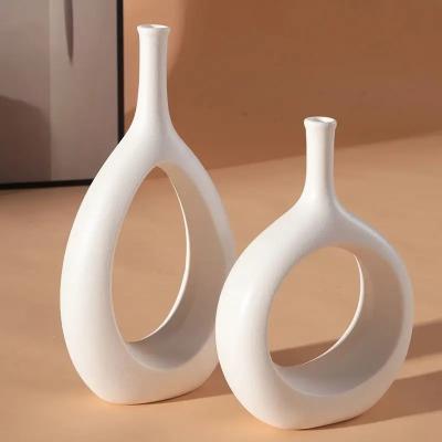 China Nordic Modern White and Black Ceramic Vase for Home Decor Desktop Interior Decorative Ceramic Hollow Out Flower Vase for sale