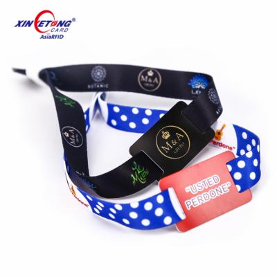 China Fabric Woven PU Leather Wristband RFID 13.56MHZ Smart Embossed Logo Wristband for sale