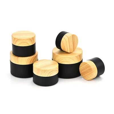 China 5g 10g 15g 20g 30g 50g Cosmetic Cream Jar Empty Black Frosted Glass Cosmetic Jar With Wood Grain Cover for sale