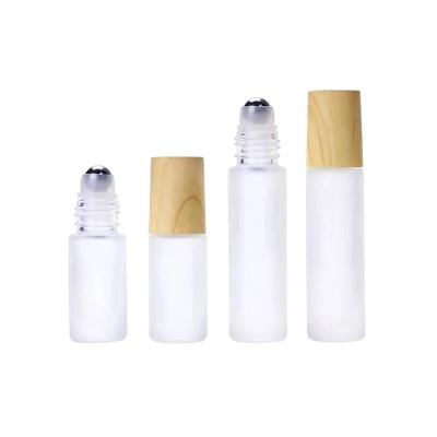 China Cosmetic Factory Frosted Glass Roll On Bottles 10ml 5ml Essential Oil Bottle With Trackball Wood Grain Cover for sale