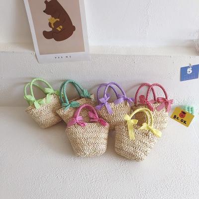 China For kids children's style 2022 new children's handbag bow woven bags 2022 new western style girl princess photo modeling straw bag for sale