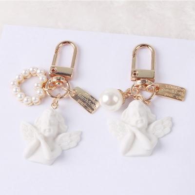 China 2022 Uinsex Key Chain Ladies Bead Heart Angel Keychain Custom Wholesale Gift Cool Key Chain for sale