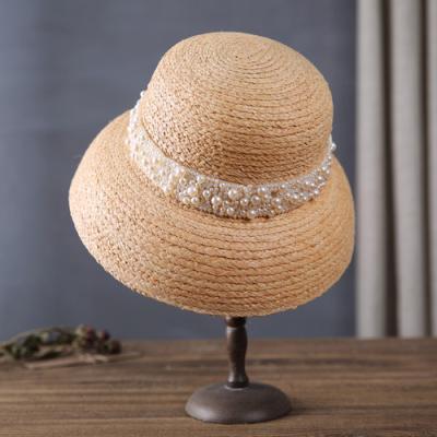 China Japanese style Clochehat fashion wild straw hats raffia parasol literary female bead striped retro hat for women 2021 for sale