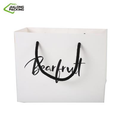 China Small Cool Black Boarder Materials Gift Bag Recycled White Coated Paper Bag For Clothing Store Can Be Printed Logo for sale