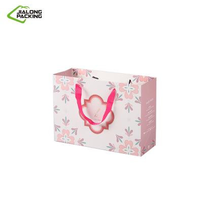 China Wholesale Custom Recycled Materials Logo Color Coated Paper Bag Pink Mailing Bag With Handle for sale