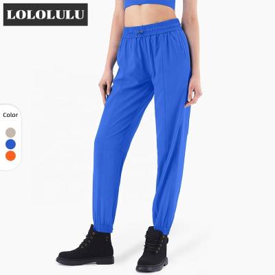 China Breathable Female Quick Dry Yoga Pants With Pockets Elastic Drawstring Sports Jogger Pants for sale