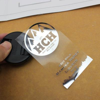 China Waterproof Custom Hot Stamping Transparent Logo Sticker , Plastic Silver Foil Embossed Die Cut Packaging Label for sale