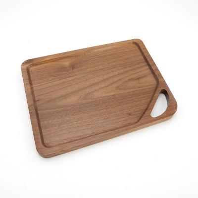 China Sustainable Amazon hot sale quality solid Large Walnut Wood cutting board With Handles for sale