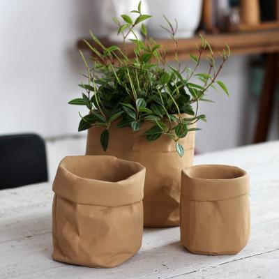 China Simple Nordic modern creative cowhide CLASSIC bag flower pot bag fabric cement home green plant pot for sale