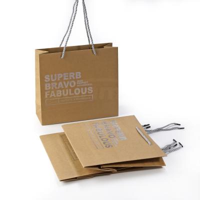 China Recyclable Custom Brown Kraft Paper Bag With Silver Foil Logo , Customized Craft Shipping Bag With Drawstrign Handles for sale