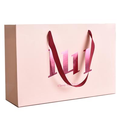 China Large Recyclable Fancy Pink Horizontal Shape Paper Carrier Bag With Custom Purple Foil Logo Design for sale