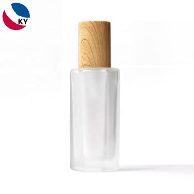 China Thick Wall And New Design Bottom Wooden Cap Hexagon Frosted Serum Glass Bottle for sale