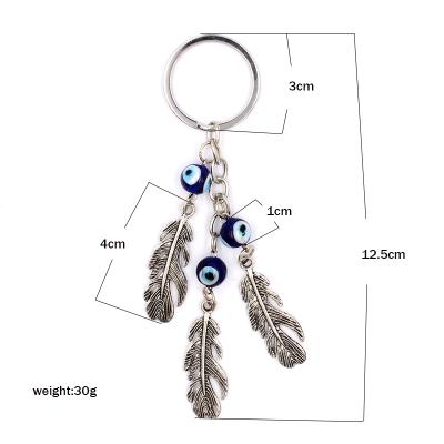 China Bag Key Palm Elephant Feather One Arrow Through Heart Three Eye Evil Eye Pendant Key Chain for sale