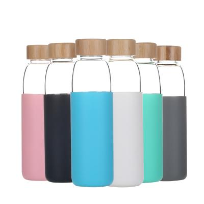 China Eco Friendly Sustainable Food Grade Custom Drinking Transparent Clear Glass Water Bottles With Bamboo Lid for sale