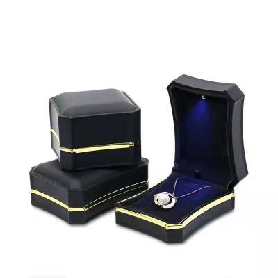 China Fashion Luxury Black Plastic Jewelry Case Lacquered Wedding Ring Pendant Jewelery Packaging With Led Light Box for sale