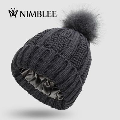 China Winter warm woman satin lined beanie hat with fur pom for sale