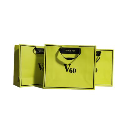 China Recycled Materials Customized Yellow Paper Bag Fashion Shopping Paper Bags With Handles for sale