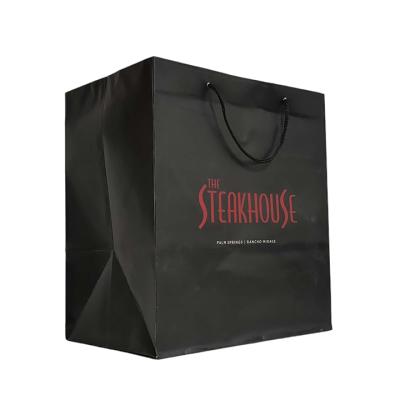 China New Recycled Logo Cotton Rope Handles Hot Foiled Stamping Black Matt Kraft Paper Bag With Materials Gold for sale