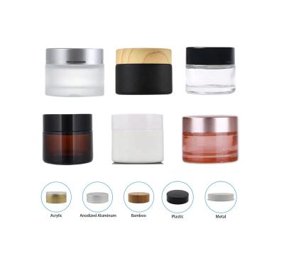 China Cheap amber glass personal care cream jars with lid small bamboo high borolicate frosted glass cosmetic jar for sale