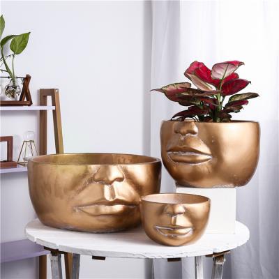 China Wholesale Multisize Luxury Gold Cement Planter Round Modern Novelty Modern Design Face Indoor Plant Pots For Home Hotel for sale