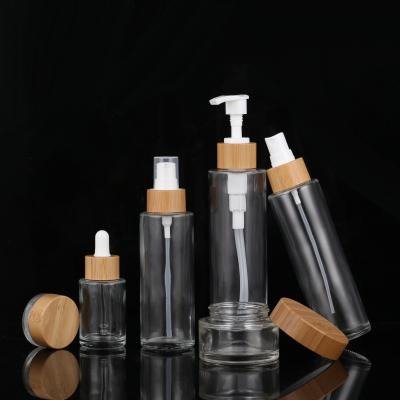 China OEM 50g 100g 150g 200g Cosmetic Glass Jar With Bamboo Lids Cream Cosmetic Jars Packaging Set for sale