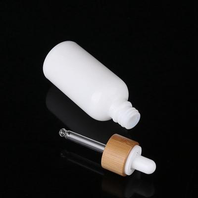 China 30 50 100ml Cosmetic Pure White Essential Oil Dropper Glass Bottle With Custom Cap for sale