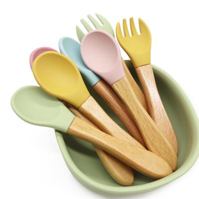 China Sustainable LOGO Food Grade Beech Wooden Custom Handle Silicone Baby Feeding Spoon for sale