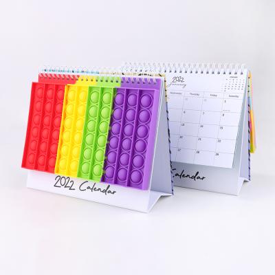 China 12 Months Desk Calendar 2022 Spiral Desk Agenda Cover Bubble Pop Silicone Eco-friendly Paper for sale