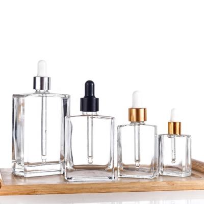 China Essential Oil Square Glass Dropper Bottles 15ml 30ml 50ml 100ml Clear Essential Oil Dropper Glass Bottles for sale