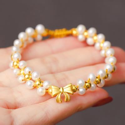 China 2023 cute new princess on gold female freshwater string bow bracelet pearl hand run braided rope for sale