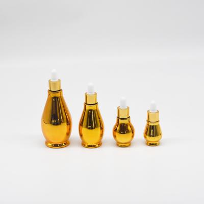 China Luxury Liquor Bottles 20ml 30ml 50ml 100ml Simple Plastic Master Dropper Pumpkin Essential Oil Gold Bottle for sale