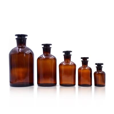 China Custom Hot Amber Round Shape Free Sample Stock Factory Medicine Empty Glass Medicine Bottle With Glass Cork for sale