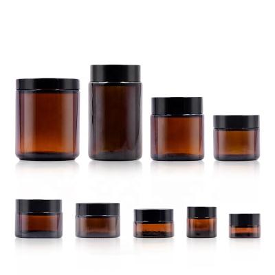 China Fashionable hot amber facial cream cosmetic candle capsule raw material sale right side glass jar storage with plastic aluminum lid for sale