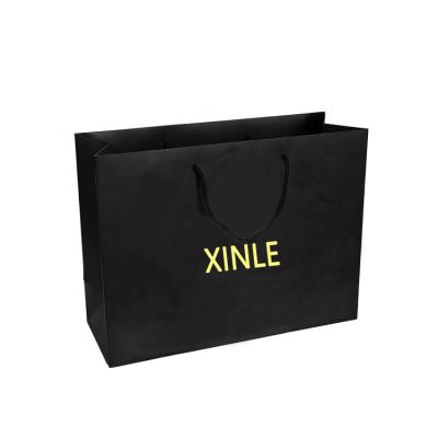 China Personality Recyclable Custom Printed Black Luxury Brand Clothing Retail Packaging Paper Bag With Logo for sale