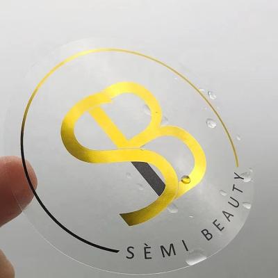 China Waterproof Custom Gold Foil Self Adhesive Private Logo Printing Roll Transparent Labels Clear Sticke for sale