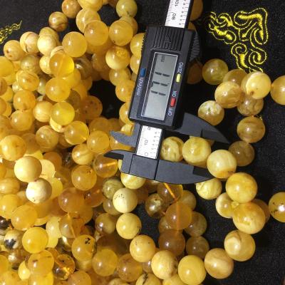 China Natural Economic Custom Design Amber Stone White And Yellow Baltic Muslim Prayer Bead Loose Ball Beads for sale