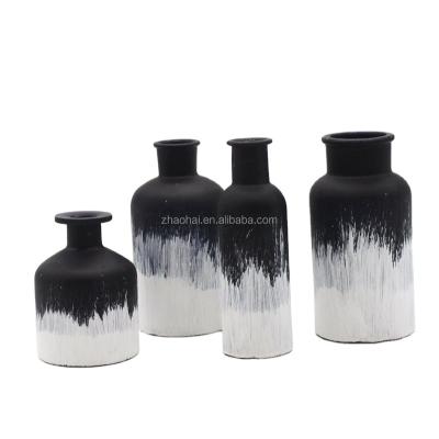 China Brushed white paint fabulous frosted black glass bottle with brushed white paint for sale