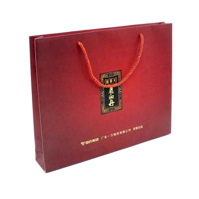 China Red color design moisture proof hot stamping luxury paper shopping bag with custom logo for perfume for sale