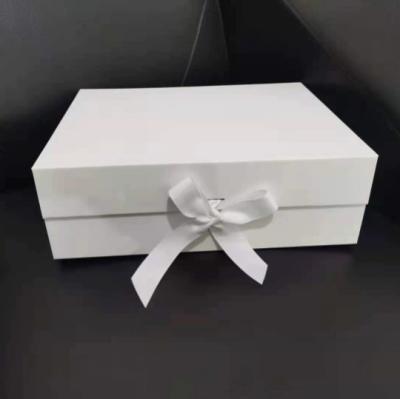 China Luxury Handcrafted Recycled Materials Black Flat Foldable Paper Gift Boxes With Ribbon Closure for sale