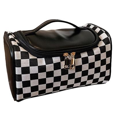 China Fashion Portable Large Fashion Cosmetic Bag PU Large Capacity Checkerboard Compartment Wash Bag Handheld Cosmetic Pillow Bag for sale