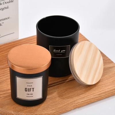 China Cylinder Candle Container Perfume Scented Candle Cup With Wood Cover Cylinder Black Empty Frosted Glass Candle Jars With Lid for sale