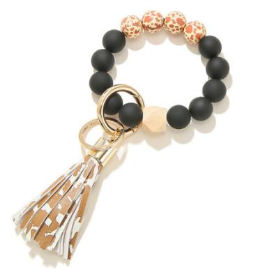 China Lovely Gift T324 Wood Beads Bracelet Key Chain For Women PU Leather Tassel Leopard Key Chain Keychain Jewelry Accessories for sale